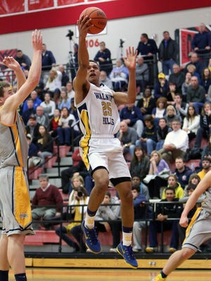 Walnut Hills guard MaCio Teague slashes to the basket and scores in the Boys Sectional Playoff game at Fairfield High School, March 6, 2015.