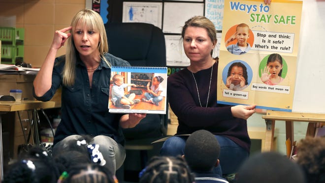 School psychologist Kate Schmidt (left) and social worker Jyl Ellmaker instruct 4-year-old students in gun safety at Pierce Elementary School. Schmidt and Ellmaker work closely with psychotherapist Jennifer Scott, who spends two days a week working with children at the school.