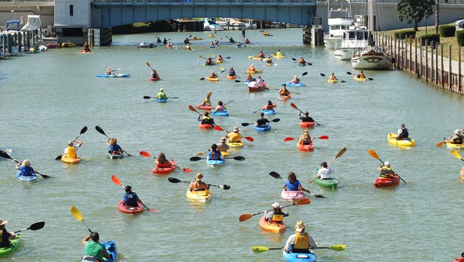 Participants head up the Black River, Sunday, Sept 8, during the Paddle and Pour event in Port Huron.