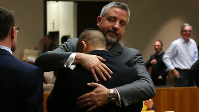 Charles Tan is hugged by attorney James Nobles after he is set free from murder charges for the killing of his father.