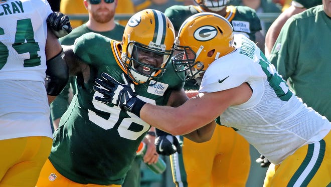 Green Bay Packers defensive end Letroy Guion (98) battles offensive guard Don Barclay (67) during training camp practice Saturday, July 29, 2017, at Ray Nitschke Field.