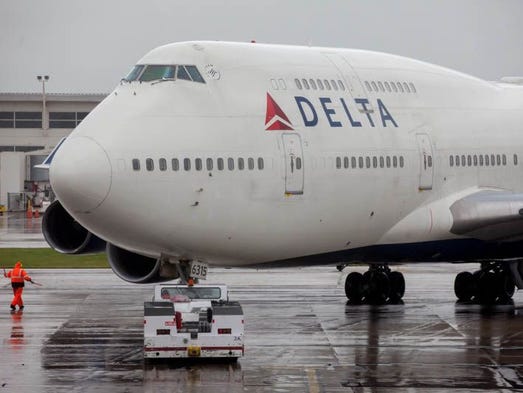 A Delta Air Lines Boeing 747-400 is pushed back for