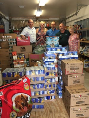 Paul Williamson (from left), Mary Williamson, Tony Donini, Michael Natale and Grace Follett, food pantry director