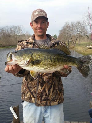 Mark Kilgore with a huge largemouth bass that he caught and released from a neighborhood pond.