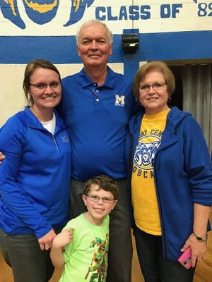 Jerry and Linda Lott pose for a picture with their daughter and former player, Kristi Davidson and her son Landon after Lott won his 800th game in January.