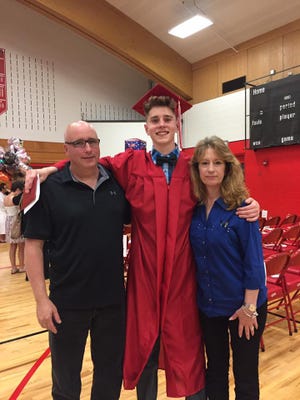 St. Francis Alderman Ken Tutaj poses for a picture with his son, Zach, and wife, Lisa, at the June graduation at St. Francis High School. Tutaj is interested in running for St. Francis mayor if a recall effort against the current mayor leads to a special election.