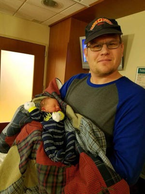 Cade Stensland with his newborn son Dec. 19. He died two days later in a freak accident.