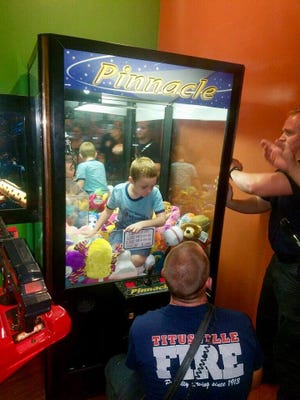 Boy gets stuck in arcade game in Titusville.