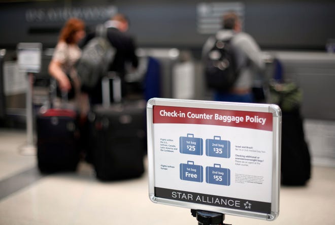 AP Photo/Matt Rourke 
A sign is seen  at a U.S. Airways check-in  at the Philadelphia International Airport Monday in Philadelphia. The 
government said Monday that airlines collected $3.4 billion in baggage fees last year, up 24 percent from 2009.
