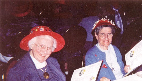 submitted photo
she will be sorely missed: Virginia Jackson (left) is seen with her friend, Rose-Marie Brisbois, during a meeting of the Red Hat Society.