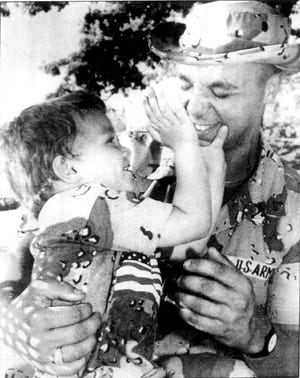 Marshfield firefighter William Chiano hugs his then 3-year-old son Tyler, after returning home with his National Guard unit from Operation Desert Storm in Iraq in May 1991.