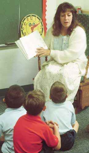 Suzy Lunsford reads 'The Giving Tree' to five-year-old kindergarten students at St. Joseph's Catholic School. Lunsford was taking part Tuesday in the school's celebration of Read Across American Day and Dr. Seuss birthday. Parents volunteered to come into the school and read their favorite book to students.