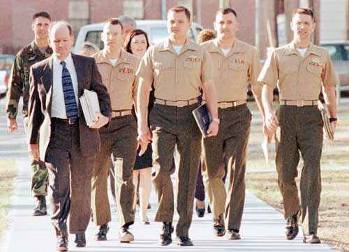 Capt. Richard Ashby, center, leads the way with his defense team as they arrive at court Wednesday during his court-martial trial at Camp Lejeune, N.C.