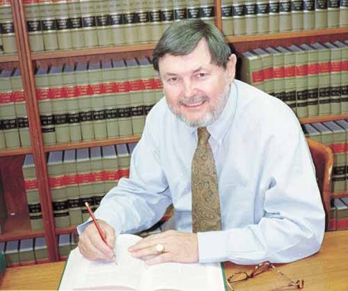 Jack Brandon is seen at his desk. Brandon says attorneys in Polk donate considerable time and energy to persons who couldn¹t otherwise afford legal services.