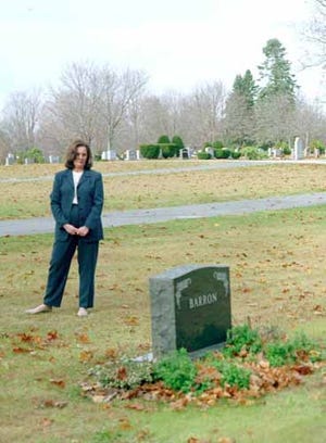 Shirley Barron stands before the grave of her husband, Bruce, in Derry, N.H., in this Nov. 1997 file photo. Barron, a 47-year-old attorney, committed suicide Aug. 6, 1996, after the Internal revenue Service put liens for back taxes on his home in Derry and on his vacation home in Chatham, Mass.