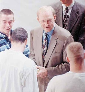 University of Missouri head basketball coach Norm Stewart, center, talks to his players from left, Brian Grawer, Jeff Hafer and Matt Rowan Thursday, April 1, 1999, just before announcing that he was stepping down after 32 years at Missouri, in a news conference at the Hearnes Center in Columbia, Mo.