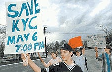 Les Gillaspie, 15, stands with supporters in front of the Kittery Youth Connection in Post Office Square in Kittery yesterday afternoon, urging passing motorists to help save the pre-teen and teen hangout.