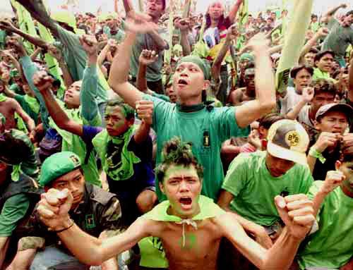 Wearing the party's green colors, supporters of the United Development Party (PPP) cheer during a rally in Jakarta Monday, May 31, 1999. Campaigning continues as Indonesia gets ready to hold its most open and multi-party elections on June7. (AP Photo/Charles Dharapak)