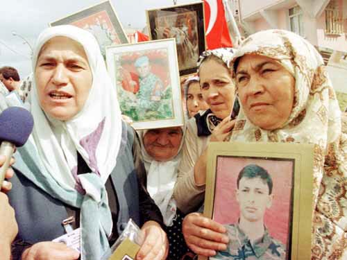 Mothers of Turkish soldiers killed during fighting with Abdullah Ocalan's rebels speak to reporters during his trial Wednesday in Mudanya, Turkey.