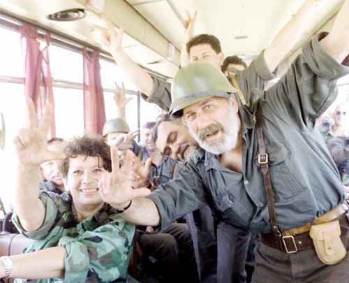Yugoslav army soldiers leaving the province of Kosovo flash a traditional Serb nationalist salute in there bus Thursday, June 10, 1999 as they head to the northern border of Kosovo at Merdare about 25 miles ( 40 kms ) north of Pristina.