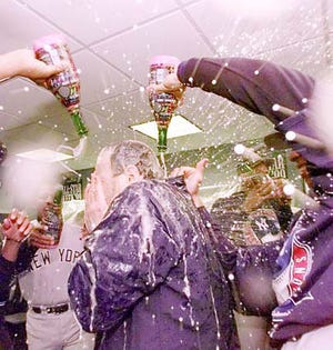 New York Yankees manager Joe Torre is sprayed with champagne following Game 5 of the American League Championship Series Monday.