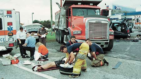 Polk County Emergency personnel work on two of the acident victims Thursday on U.S. Highway 27 at the Interstate 4 interchange.