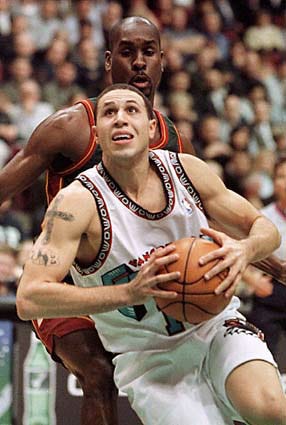 Vancouver Grizzlies guard Mike Bibby (10) eyes the hoop as Seattle SuperSonics guard Gary Payton (20) looks on during first quarter NBA action at GM Place in Vancouver on Thursday.