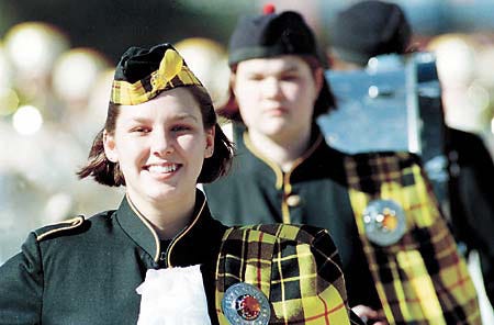 Erin Thomas marches with the Scottish Unit Dancers on Saturday morning during the Lake Wales Kiwanis Christmas Parade.