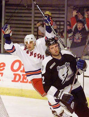 New York Rangers right wing Alexandre Daigle reacts after scoring against the Tampa Bay Lightning in the second period Sunday, Dec. 19, 1999 in New York. Defending is Paul Mara of the Lightning. The Rangers won 5-4 in overtime. (AP Photo/Mark Lennihan)
