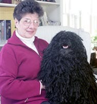 Carolyn Nusbickel of Eastham sits with her dog, affectionately known as Matilda, a Puli who captured best-of-breed honors for the third year in a row at the prestigious Westminster Kennel Club Dog Show. The competition was held at New York's Madison Square Garden earlier this week.