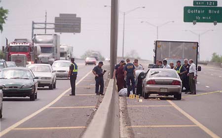 Police and emergency response personnel gather Thursday at the scene of a shooting in the southbound lanes of Interstate 95 in North Jacksonville. A 30-year-old, unarmed man claiming to be Jesus Christ was shot and killed by police detective Thomas Herrington. According to Jacksonville Sheriff's Office Chief Frank Mackesy, the man was obstructing traffic when Herrington pulled his unmarked vehicle over. The man approached the detective's car and broke a hole in the back window.