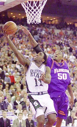 Michigan State's Mateen Cleaves (12), left, goes for the basket as Florida's Udonis Haslem (50) defends in the second half of the NCAA Championship at the RCA Dome in Indianapolis Monday, April 3, 2000.