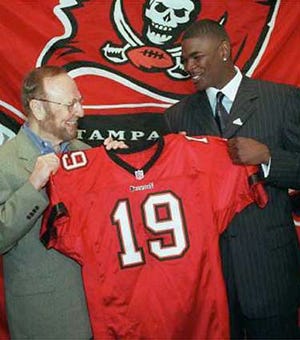 Tampa Bay owner Malcolm Glazer and newly acquired wide receiver Keyshawn Johnson pose with Johnson's new jersey.