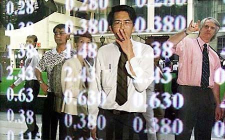 Singaporeans are reflected in the glass of a screen showing share prices as stock prices rebound in early trading Tuesday in Singapore.