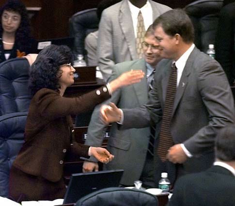 Florida state Rep. Paula Dockery, R-Lakeland, left, is approached for congratulatory hugs by Rep. Charles Sembler, R-Sebastian, right, and Rep. Adam Putnam, R-Bartow, center, after Dockery's hotly debated Submerged Lands Bill cleared second reading clean of any unfriendly amendments Thursday in Tallahassee.