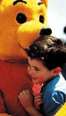 Michael Hoeing, 3, of Rye, gets a hug from Winnie The Pooh at the Isles of Shoals Steamship Co. at the start of Sunday's Pro Portsmouth-organized Children's Day.

Photo by