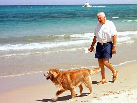 Bob Reis, walks his retreiver "Winnie" on her 7th birthday along the beach in Jupiter, Wednesday. Winnie also makes weekly trips to visit 4-10 year olds at a local children's hospital in Palm Beach County. A two mile stretch of the beach is open to small pets.