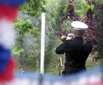 Retired U.S. Marine J.D. Vasquez plays taps during a Memorial Day ceremony at the Massachusetts National Cemetery in Bourne. The 20th annual ceremony featured music by the 215th Army Band and Cranberry Shores Chorus Sweet Adelines, and a flyover by the Air National Guard's 102nd Fighter Wing out of Otis Air Base.