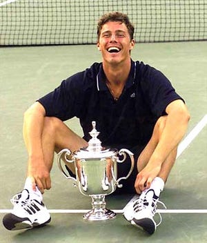 Russia's Marat Safin smiles as he sits on the court with his trophy after defeating the United States' Pete Sampras 6-4, 6-3, 6-3 in the men's singles final at the U.S. Open.
