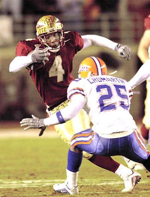 Florida State receiver Anquan Boldin (4) tries to avoid the tackle of Florida's Robert Cromartie (25) during the first half at Doak Campbell Stadium in Tallahassee on Saturday night.