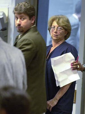 Glenda Dowis, right, stands by public defender Dan Dias at her arraignment in West Palm Beach on Wednesday. Dowis of Fort Pierce, is charged with false imprisonment and domestic assault after she told clinic nurses she would shoot her daughter if she didn't go through with an aborton. She was held without bond.