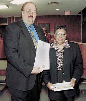 Winter Haven Mayor Scott Girouard presents a proclamation and the key to the city to Mamie Brokenburr Philip, who accepted it on behalf of her son, Kenny Brokenburr.