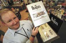 On the birthday of John Lennon, Eric Abney, store manager at Barnes & Noble in Newington, displays "The Beatles Anthology," which was written by the surviving Beatles and Yoko Ono, widow of John Lennon.
