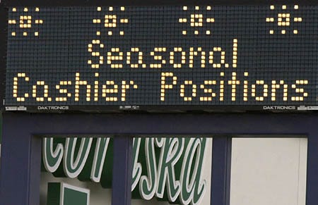 An illuminated billboard in front of an Omaha, Neb., department store, shown Friday, Oct. 27, advertises the need for cashiers for the holiday season.