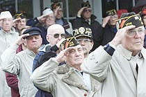 Lou Morea of Yarmouthport, second from right, joins fellow veterans in a salute while taps is played at the close of the Veterans Day ceremonies at the Yarmouth Town Hall yesterday.