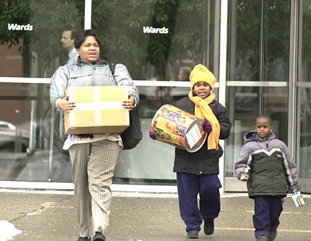 Sonya Russell, a short-time employee with Montgomery Ward Inc., leaves the corporate headquarters with belongings, with her children, Ciara Stewart, 8, and Solomon Russell, 3, Thursday in Chicago before an official announcement that the company would be shutting down after more than 125 years in business.