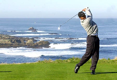Tiger Woods follows his shot from the scenic fourth tee at the Spyglass Hill Golf Course during first round play of the AT&T Pebble Beach National Pro-Am in Pebble Beach, Calif., Thursday.