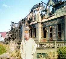 Software mogul Peter Norton, at the charred remains of his historic 19th century Victorian mansion in Oak Bluffs, has vowed to restore the home to its former glory. The house was unoccupied when a fire broke out late Monday afternoon.