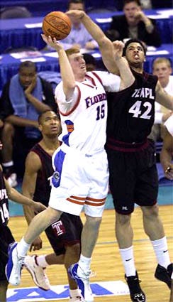 Florida's Matt Bonner (15) goes up for a jump shot as Temple's Kevin Lyde tries to block the shot. The Gators were eliminated from the NCAA Tournament Sunday.