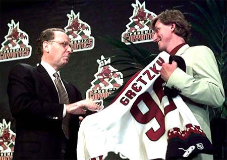 Hockey great Wayne Gretzky, right, is handed a Phoenix Coyotes jersey by Coyotes lead investor Steve Ellman in June 2000. The Gretzky era began Thursday for the Phoenix Coyotes as the former hockey great and Ellman completed their $88 million deal to buy the team.